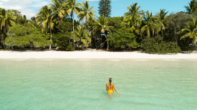 A woman coming out of the water in Kuto Bay.